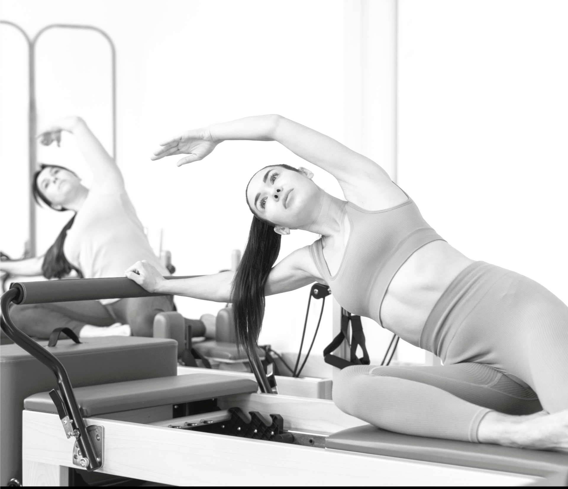 Client performing a mermaid stretch on a reformer at Valley Studio